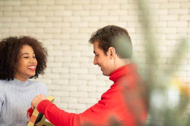 Two people at a meeting giving each other gifts. One person is handing the gift over with both hands.