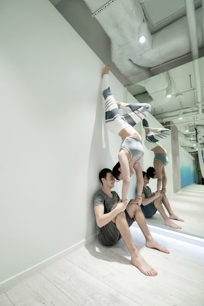 A group of teenagers rehearsing K-Pop choreography in a dance studio; mirrors line one wall.