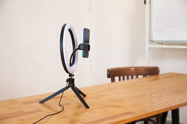 A close-up of a condenser microphone on a desk next to a high-quality webcam and a ring light, showcasing the essential equipment for recording high-quality reaction videos.