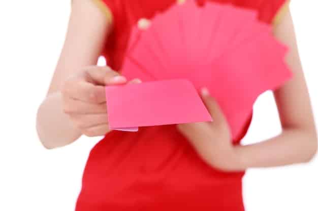 Close-up shot of a fan respectfully handing a small, neatly wrapped gift to a K-Pop idol during a fan meet. The idol is smiling politely and accepting the gift. The scene emphasizes the importance of appropriate gift-giving etiquette.