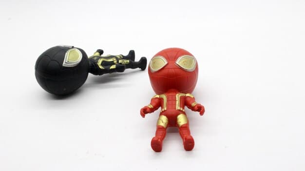 A close-up shot of various geeky items, such as miniature figurines, keychains, enamel pins, and stickers, neatly arranged to showcase the variety and detail typically found in US geek subscription boxes.