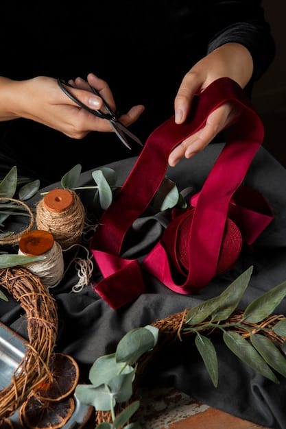 A close-up shot of a cosplayer's hands meticulously working on sewing a piece of fabric for a costume. The fabric is brightly colored and textured, showcasing intricate stitching and attention to detail. The background is slightly blurred, putting focus on the hands and the craftwork.