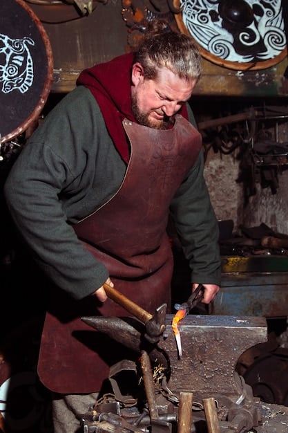 A cosplayer expertly using a heat gun to shape and mold EVA foam into a piece of armor. The workshop is well-lit and equipped with various crafting tools.