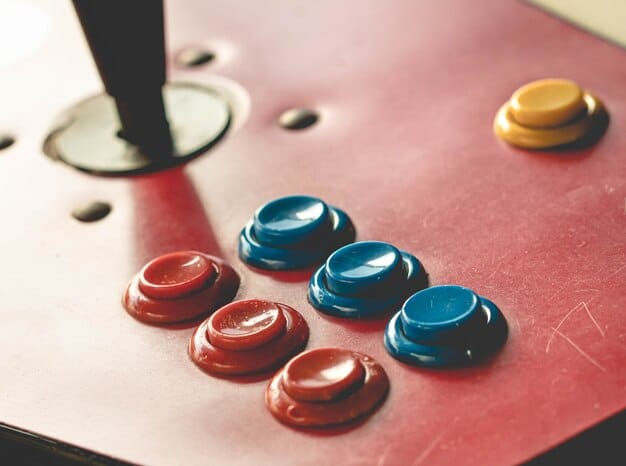 A close-up shot of a Raspberry Pi board connected to arcade buttons and a joystick, illustrating the ease and affordability of building a retro gaming system. The wires are neatly arranged, and the background is a workbench with various electronic components.