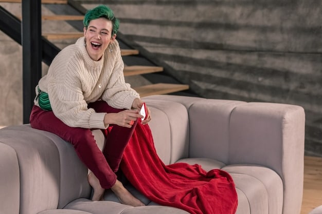 A person lounging comfortably on a couch, wearing a luxurious cashmere loungewear set in a muted gray tone. The set includes a relaxed-fit sweater and matching joggers, styled with simple gold jewelry and cozy socks. The scene is warm and inviting, highlighting the comfort and style of the loungewear.