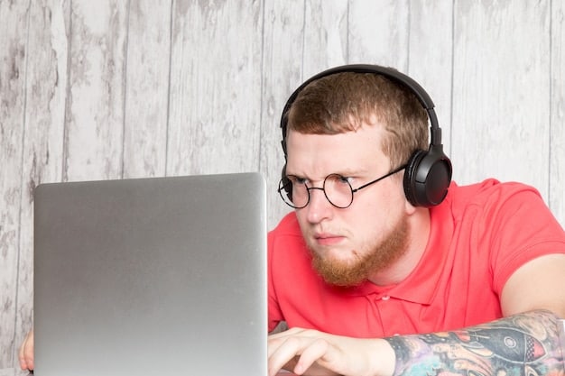 An individual wearing headphones and looking attentively at a laptop screen, surrounded by various geek-themed collectibles such as figurines and comic books, suggesting immersive listening and dedicated fandom.