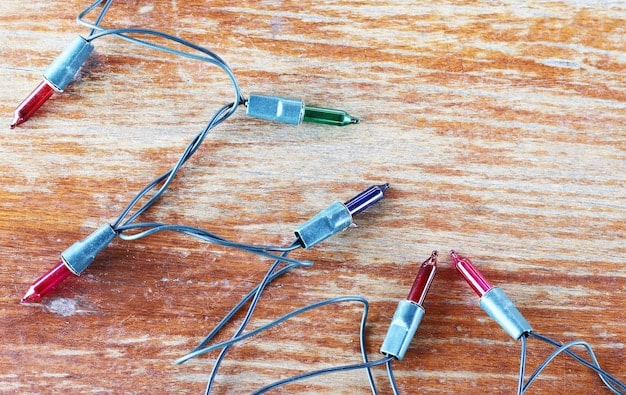 A close-up shot of a breadboard with various electronic components (resistors, LEDs, a small speaker) connected by jumper wires. A wiring diagram is visible in the background.