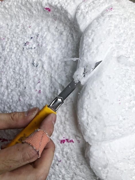 A cosplayer carefully shaping EVA foam into a piece of armor, showcasing the heat-shaping technique used to mold the foam into the desired form. Close attention to detail and texture.