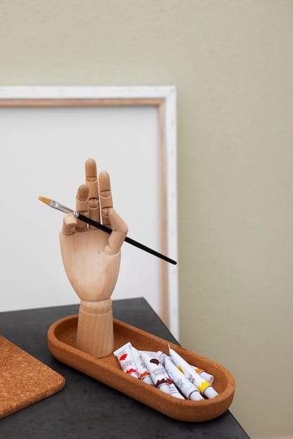A close-up shot of a person's hands meticulously painting a miniature figurine for a tabletop game. The background includes a cluttered workspace with various paints, brushes, and other miniature figures.
