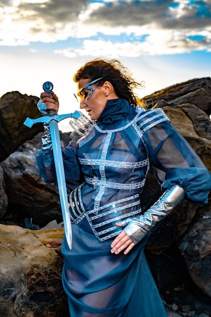 A cosplayer showcasing a meticulously crafted prop sword, demonstrating its detailed design and realistic finish. The cosplayer is dressed in a character-appropriate costume, holding the sword confidently.