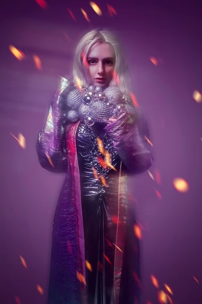 A cosplayer dressed as a powerful sorceress character, striking a commanding pose with magical energy effects Photoshopped in. The background is blurred to focus on the cosplayer and their dynamic pose, emphasizing their embodiment of the character.