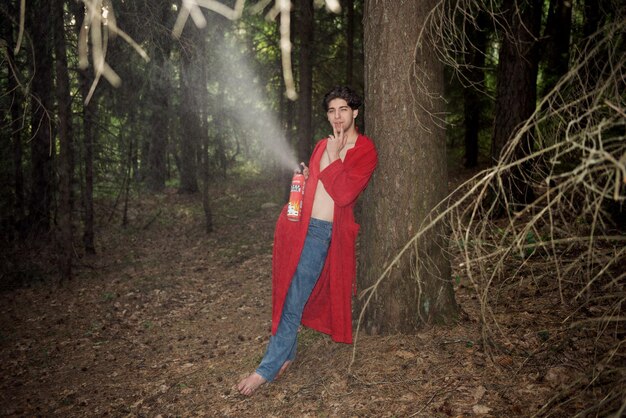 A cosplayer in a detailed outfit stands in soft, diffused light under a large tree, holding a prop sword. The lighting is even, reducing harsh shadows and highlighting character details. The background is blurred, focusing attention on the cosplayer.