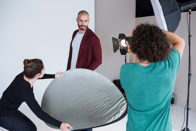 A photographer is setting up a softbox next to a cosplayer in a studio setting. The cosplayer is dressed as a futuristic warrior, and the soft, diffused light from the softbox highlights their facial features and costume without harsh shadows.