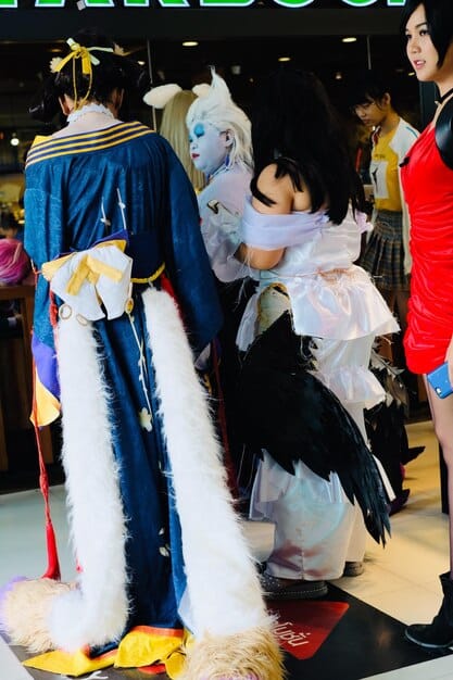 A panoramic shot of a cosplay convention, filled with cosplayers in various costumes. The image captures the energy and excitement of the event, showcasing the diversity and creativity of the cosplay community. Attendees are interacting with each other, posing for photos, and browsing vendor booths.