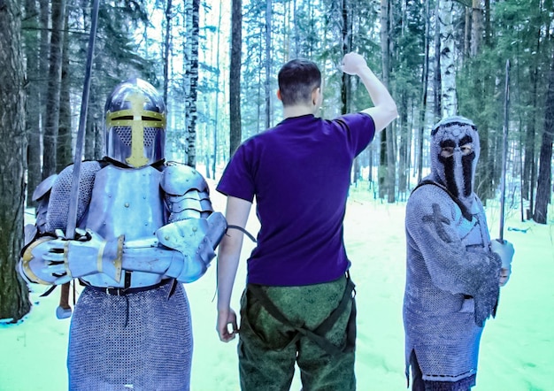 A cosplay photograph of a group of cosplayers dressed as characters from a fantasy video game, standing together in a forest with dappled sunlight filtering through the trees.