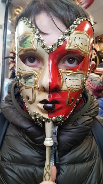 A close-up shot of a cosplayer's detailed costume, showcasing intricate craftsmanship and attention to detail. The cosplayer is smiling, reflecting pride in their creation.