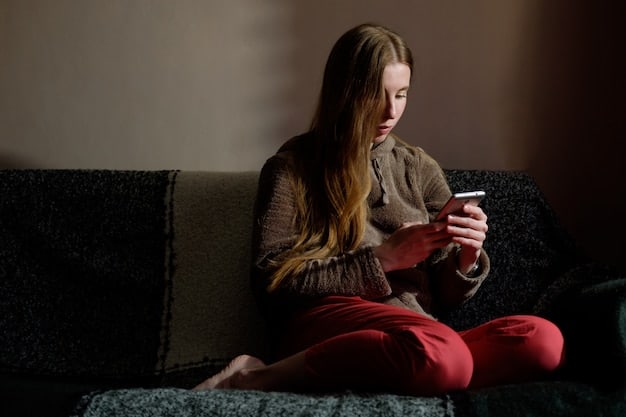 A young person sitting alone in a dimly lit room, looking at their phone with a distressed expression. The scene is framed to convey a sense of isolation and the potential impact of online harassment on mental well-being.