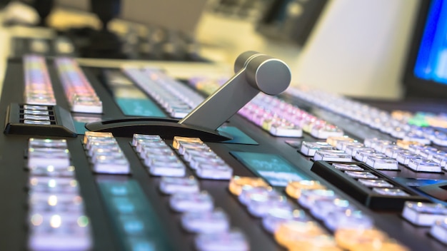 A close-up shot of a stern-looking judge's gavel hitting a soundboard used for mixing K-Pop music, symbolizing the legal consequences for copyright infringement in the K-Pop industry.
