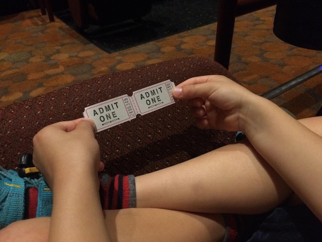 A close-up of a fake K-Pop concert ticket, highlighting the common signs of forgery such as blurry text, incorrect logos, and mismatched fonts.