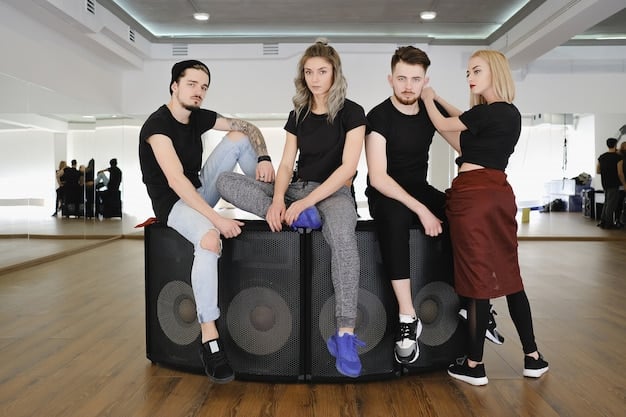 A K-pop dance class in a studio in the US. The instructor is demonstrating a move, and the students are actively following along. The studio has posters of famous K-pop groups, creating an immersive and inspiring environment.