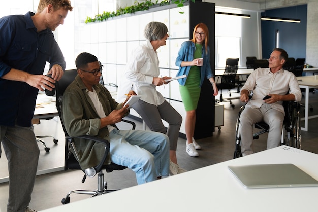 A view of a group of businesspeople is gathered around a table in a room during a gift exchange, with one person smiling as they receive a wrapped package. The atmosphere suggests a celebration or formal occasion, and it captures the sense of respect and gratitude among the business associates.