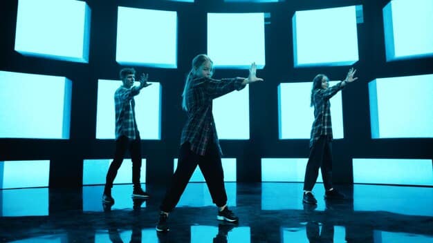 A split-screen showing a K-Pop group performing a dance routine on one side and fans recreating the same routine in their homes on the other side.