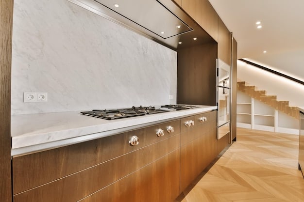 A modern kitchen interior with light wood cabinetry, white countertops, and a backsplash featuring a subtle pattern inspired by traditional Korean bojagi patchwork. The overall color scheme is neutral with pastel accents, creating a serene and inviting atmosphere.