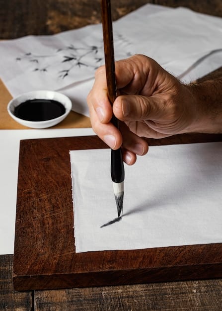A close-up shot of a hand writing Hangul characters with a calligraphy pen on traditional paper. The focus is on the elegance and precision of the strokes.