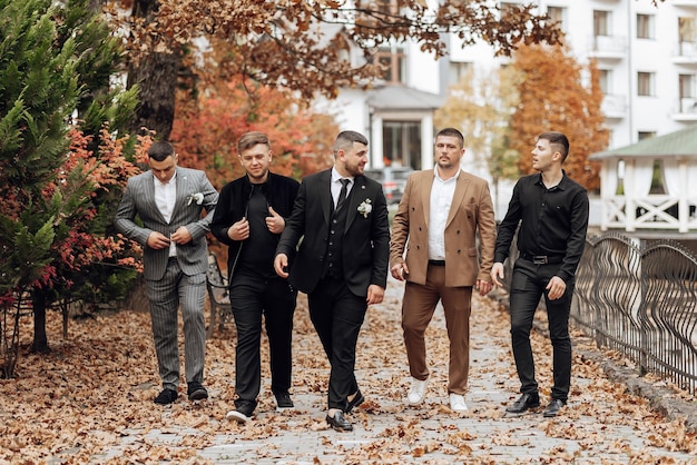 A group of wedding guests dressed in modern formal attire at a Korean wedding. The women are wearing dresses in muted tones and the men are in suits.