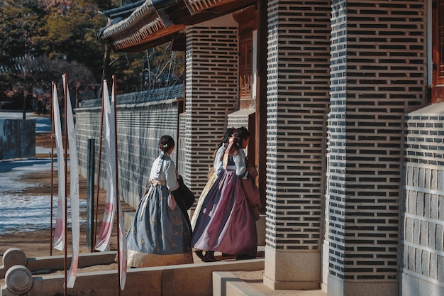 A well-stocked Hanbok boutique in Koreatown, Los Angeles, featuring various Hanboks on display. Customers are browsing through the selections, and the store's interior is bright and welcoming.