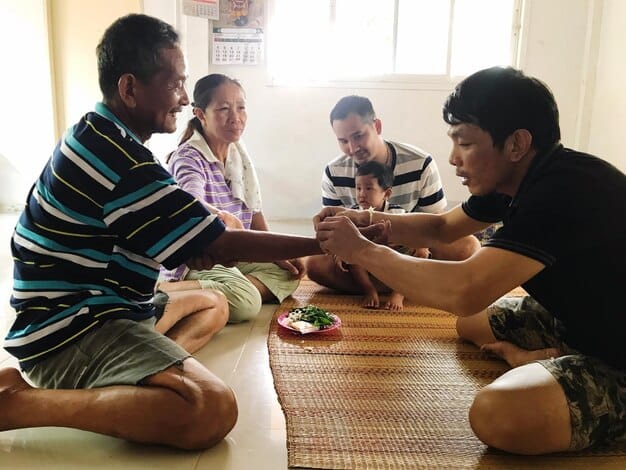 A group of Korean-American children and adults playing traditional Korean games like Yut Nori (a board game played with sticks) and Jegichagi (a Korean version of hacky sack) during a Seollal celebration in a community center in the US. The image should convey a sense of fun, excitement, and cultural engagement.