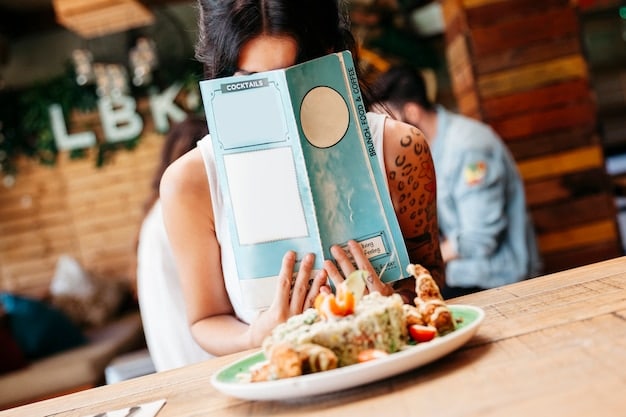 A close-up shot of a Korean menu with English translations, highlighting key phrases for ordering food, with a waiter assisting a US traveler.