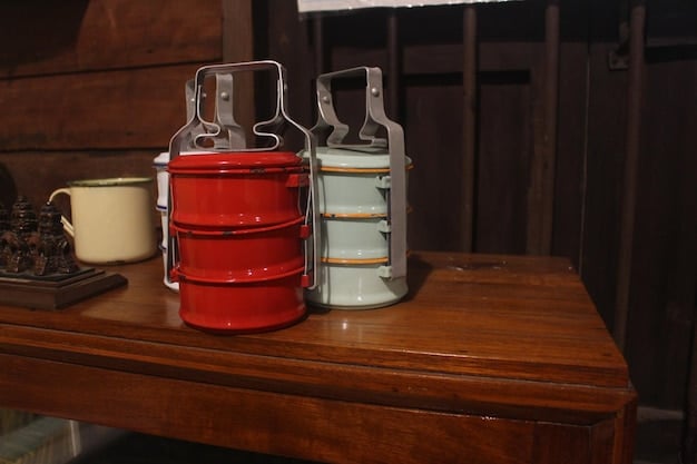 Several glass kimchi fermentation jars filled with brightly colored kimchi, sitting on a kitchen counter. The jars are partially submerged in small tubs of water to create an airlock system.