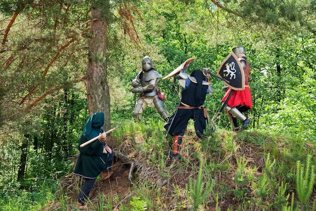 A historical depiction of Silla warriors (Hwarang) practicing martial arts techniques in a mountainous, forested setting in ancient Korea. The warriors are dressed in traditional garb, engaged in various stances and movements that showcase early forms of Taekwondo.