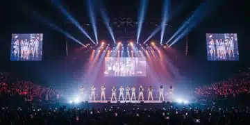Vibrant K-Pop concert stage with lights and cheering crowd