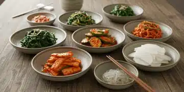 Seven colorful Korean side dishes, banchan, arranged beautifully on a wooden table, ready to be enjoyed.