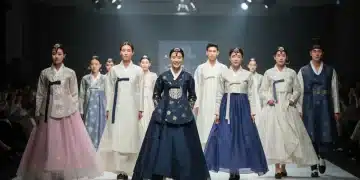 Models on a runway showcasing contemporary Hanbok designs, vibrant and elegant.